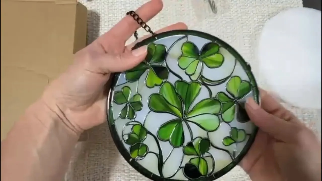 Stained glass lucky clover sun catcher full view being held with green clover design